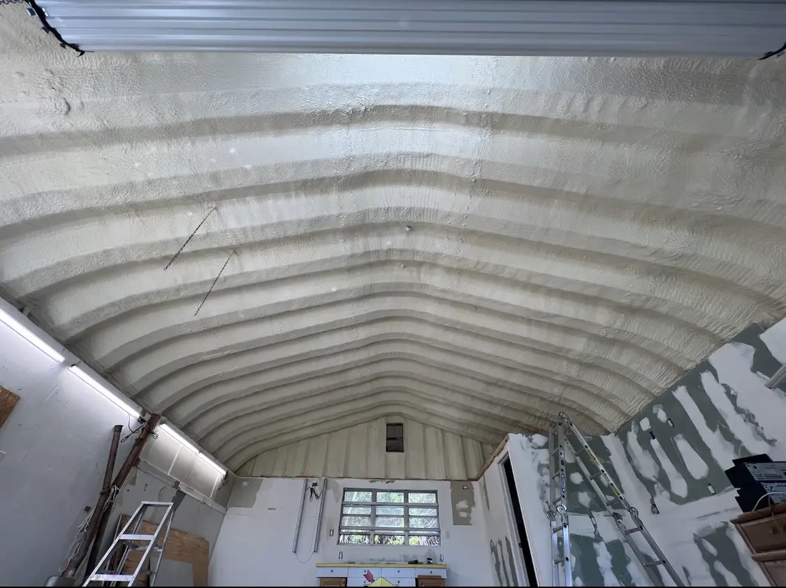 Spray polyurethane foam applied to the underside of a metal roof deck in Ceres